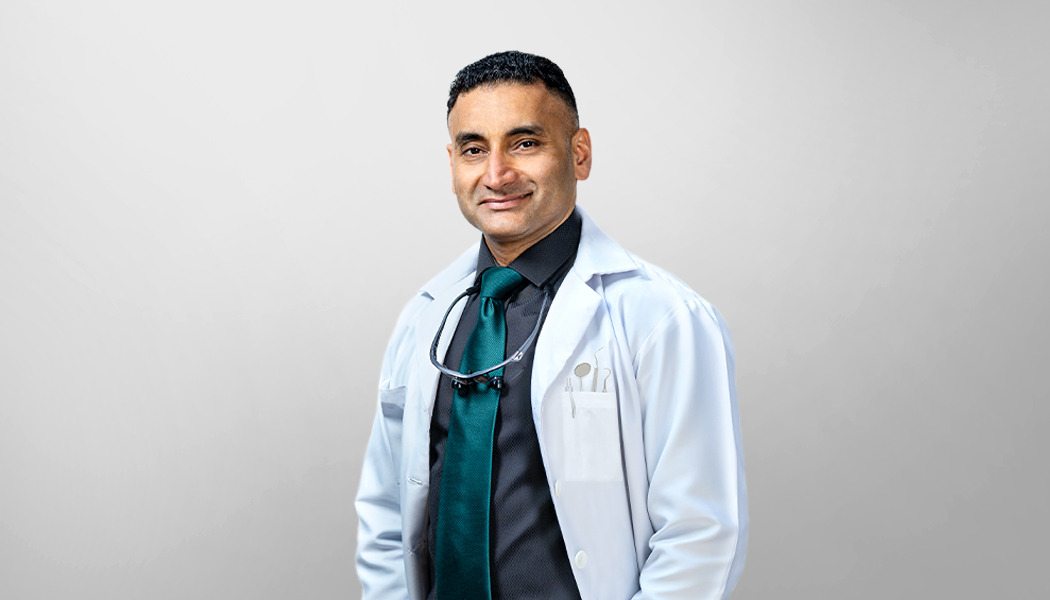 Medical doctor in a black shirt and green tie